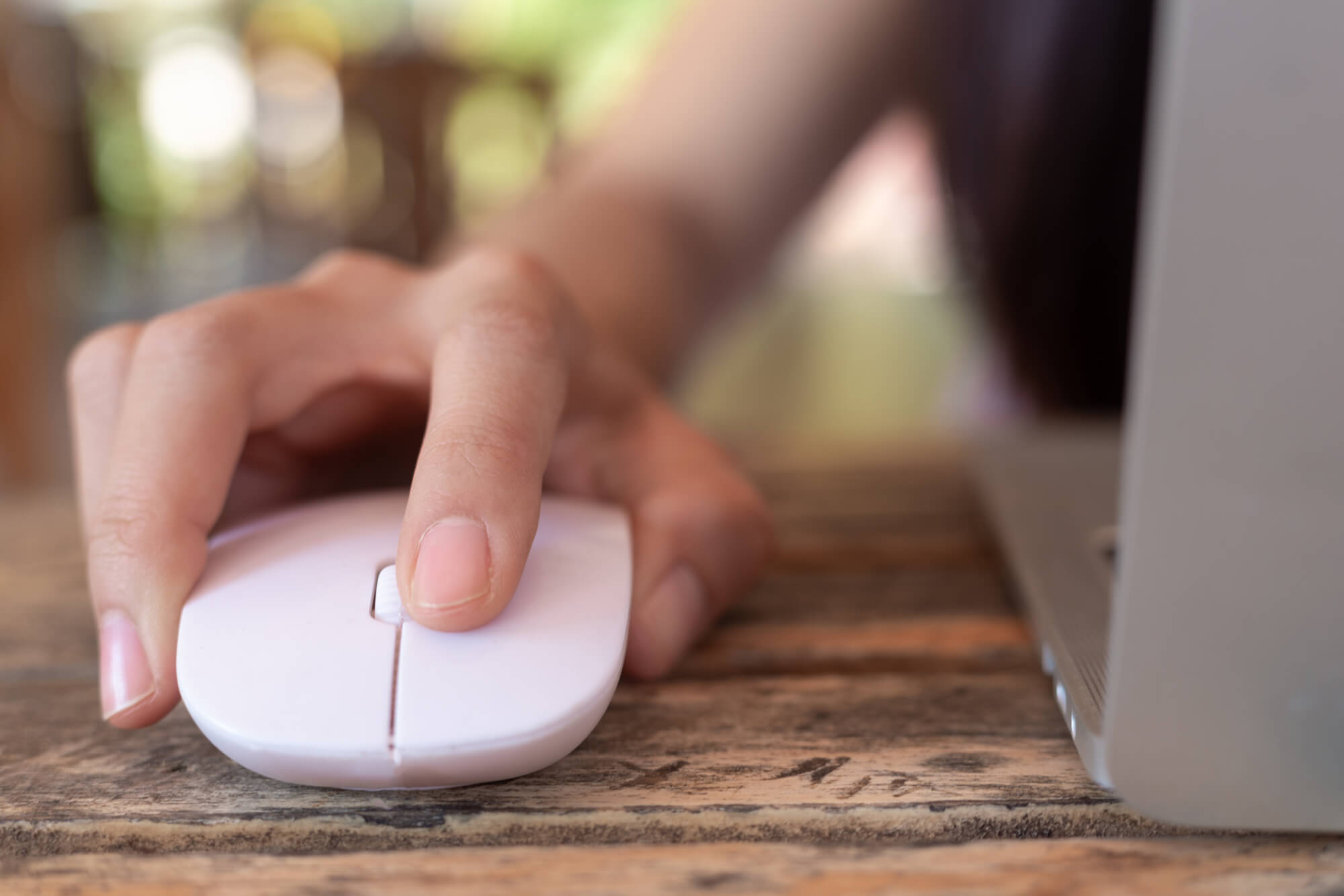 Woman Using Computer Mouse With Laptop.