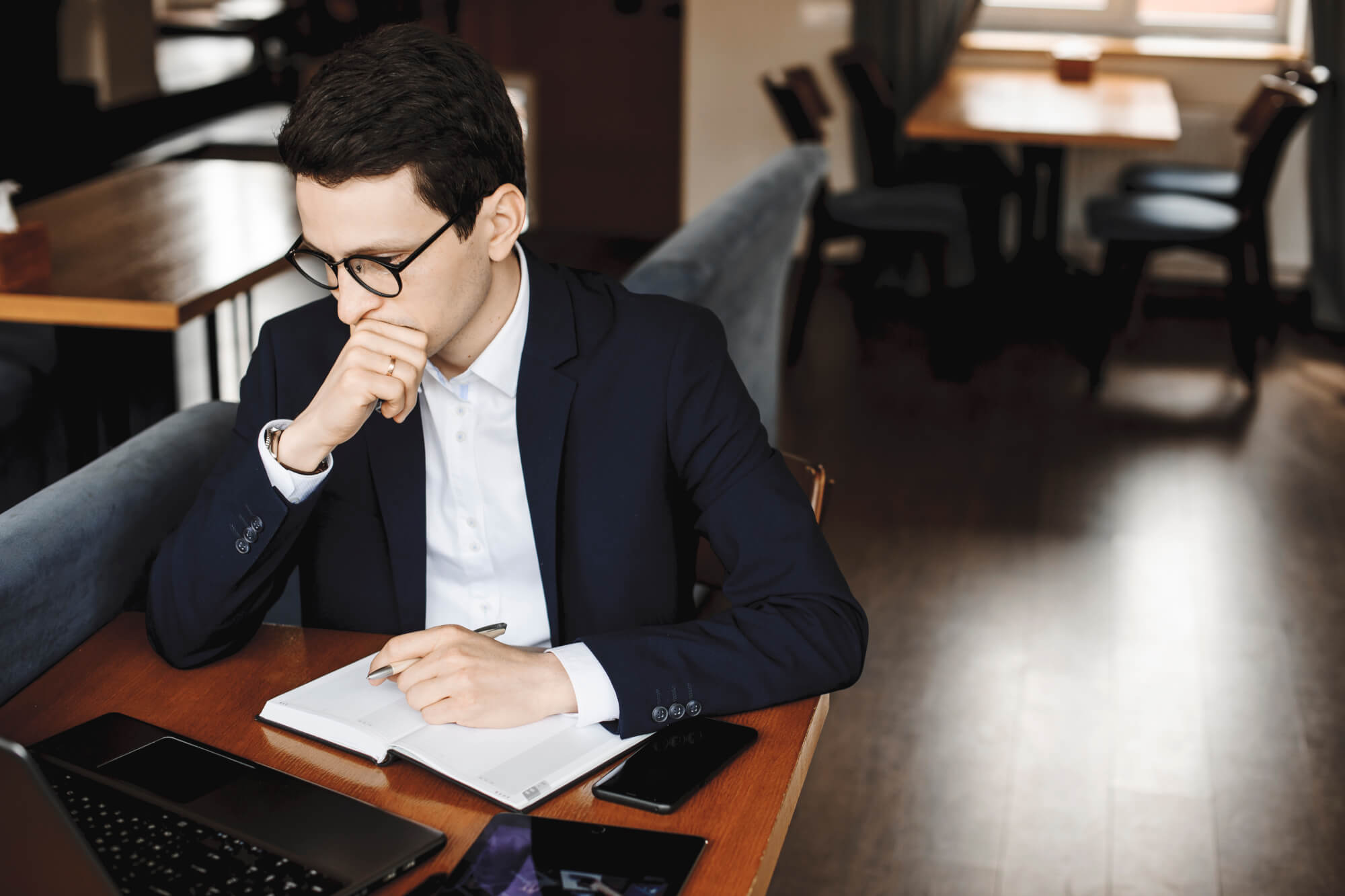 Portrait Of A Young Confident Business Man Working While Sitting