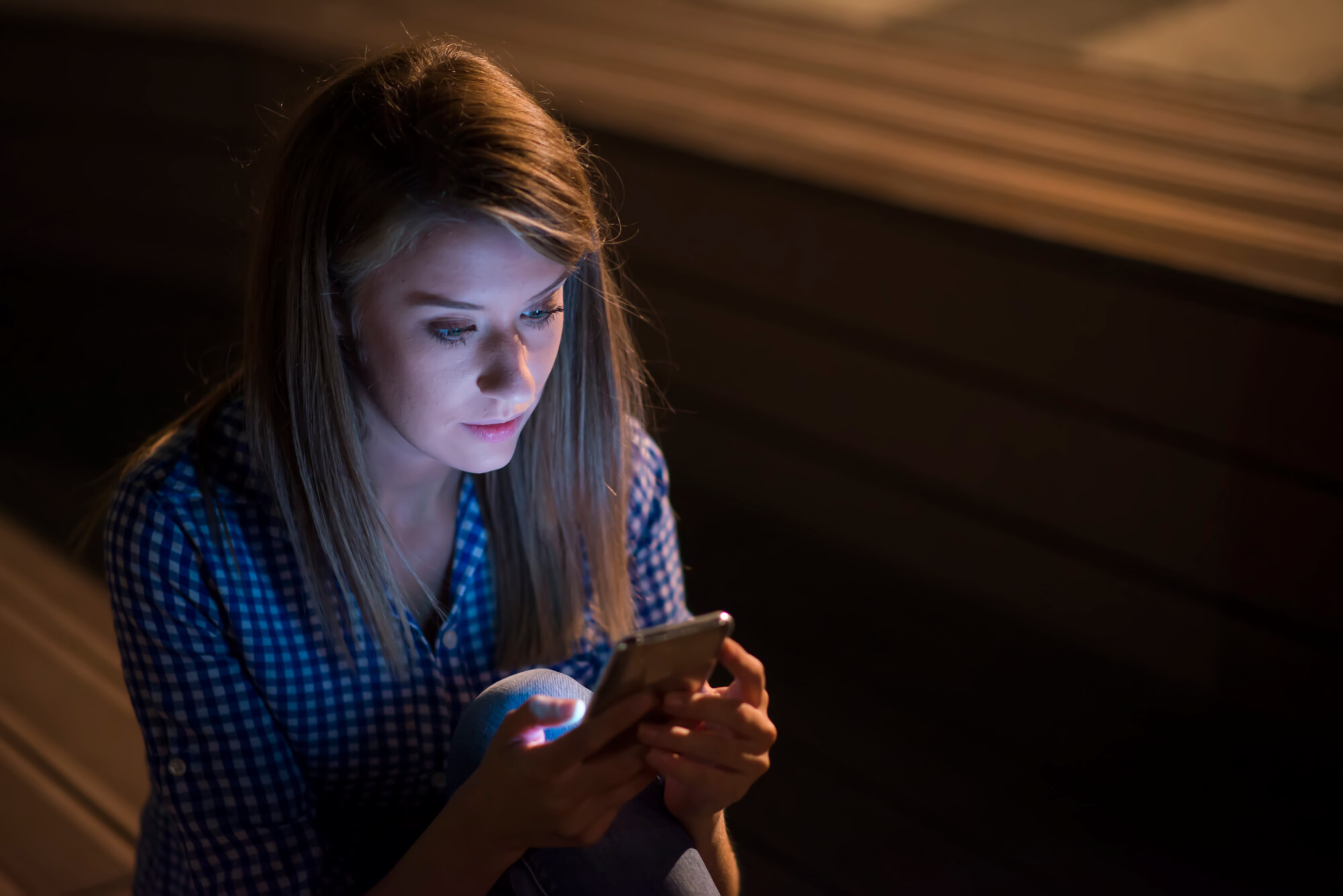 Upset Unhappy Woman Holding Cellphone Isolated On Gray Wall Back