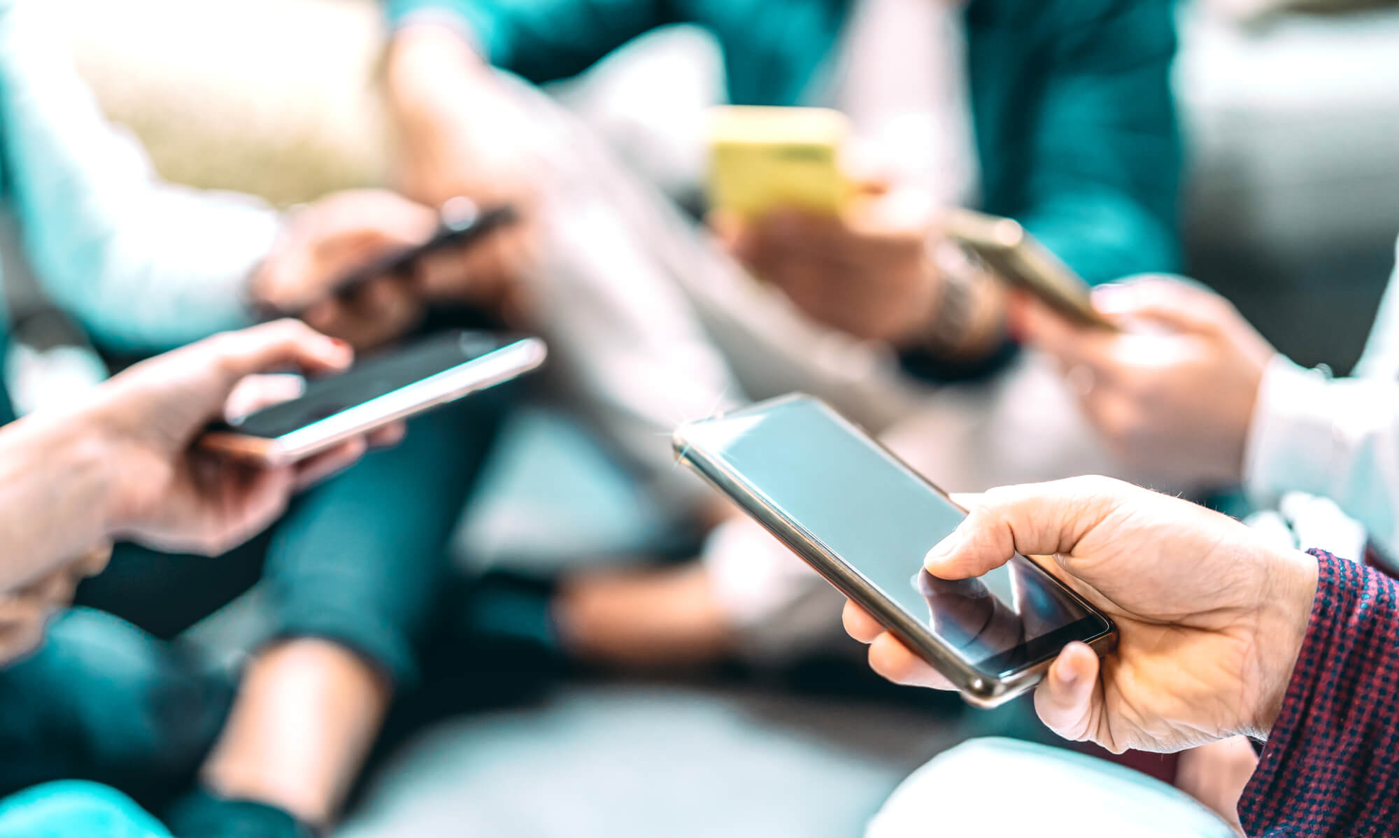 Close up of people using mobile smart phones – Detail of friends
